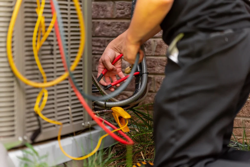 T. Byrd's Heating and Air technician working with an AC