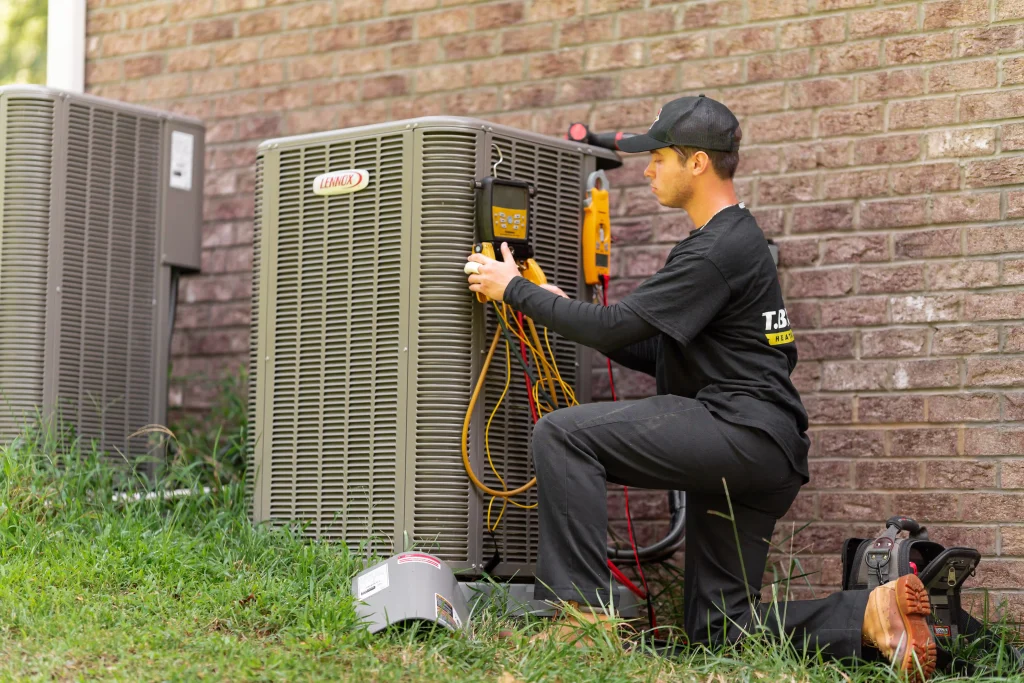 T. Byrd's Heating and Air technician repairing an AC
